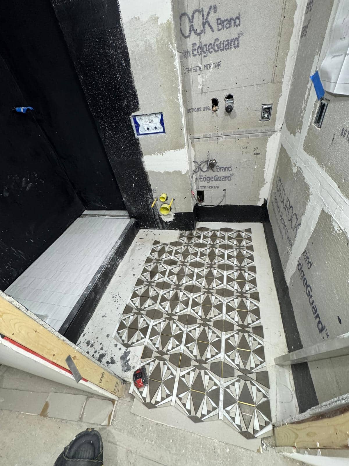 The patterned floor is already a strong feature while nearby surfaces remain unfinished.