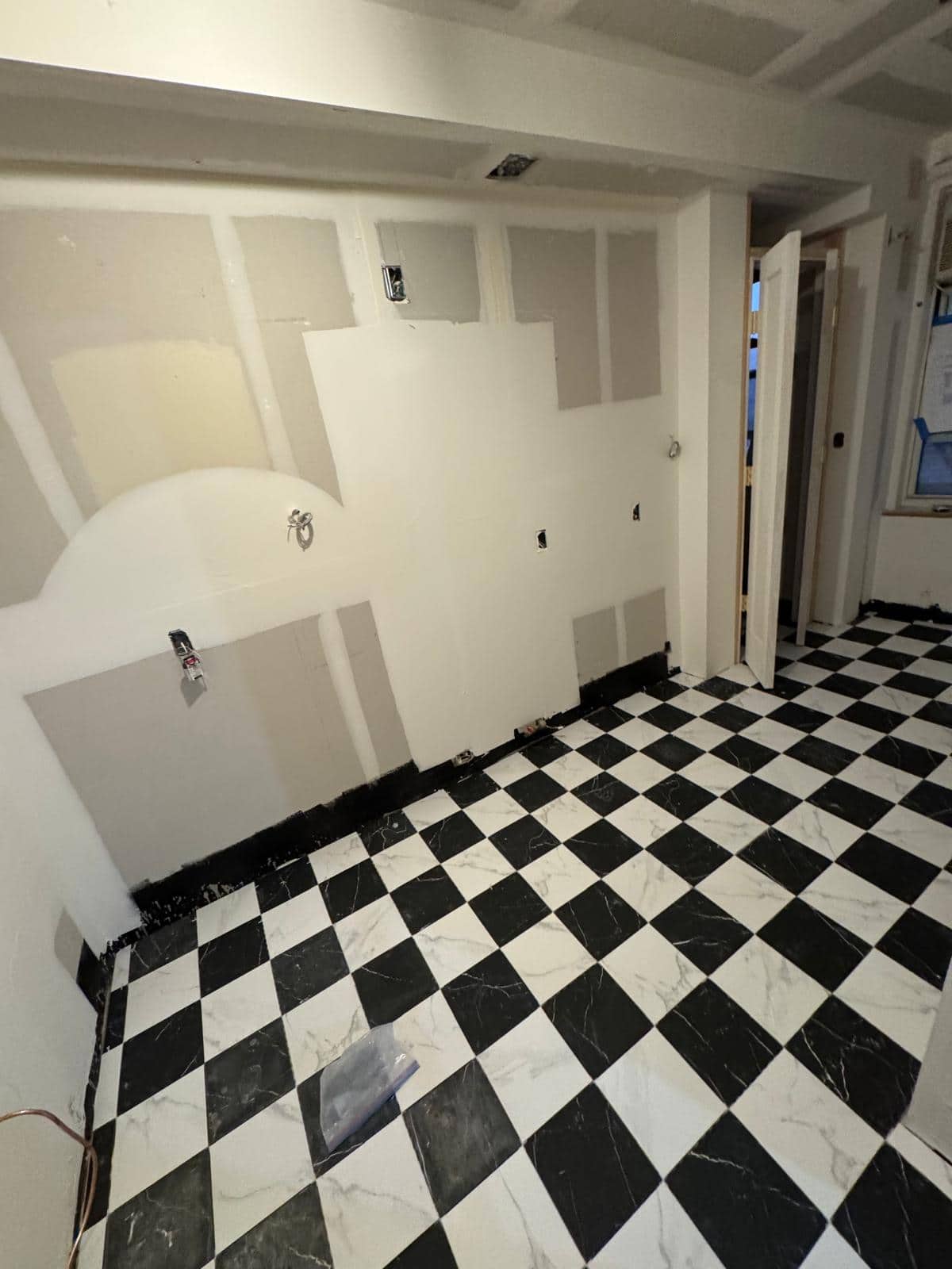 Black and white squares give this unfinished room a clear graphic floor.