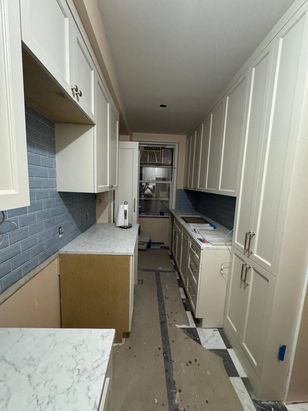 This photograph catches a kitchen before the finishing work is complete.