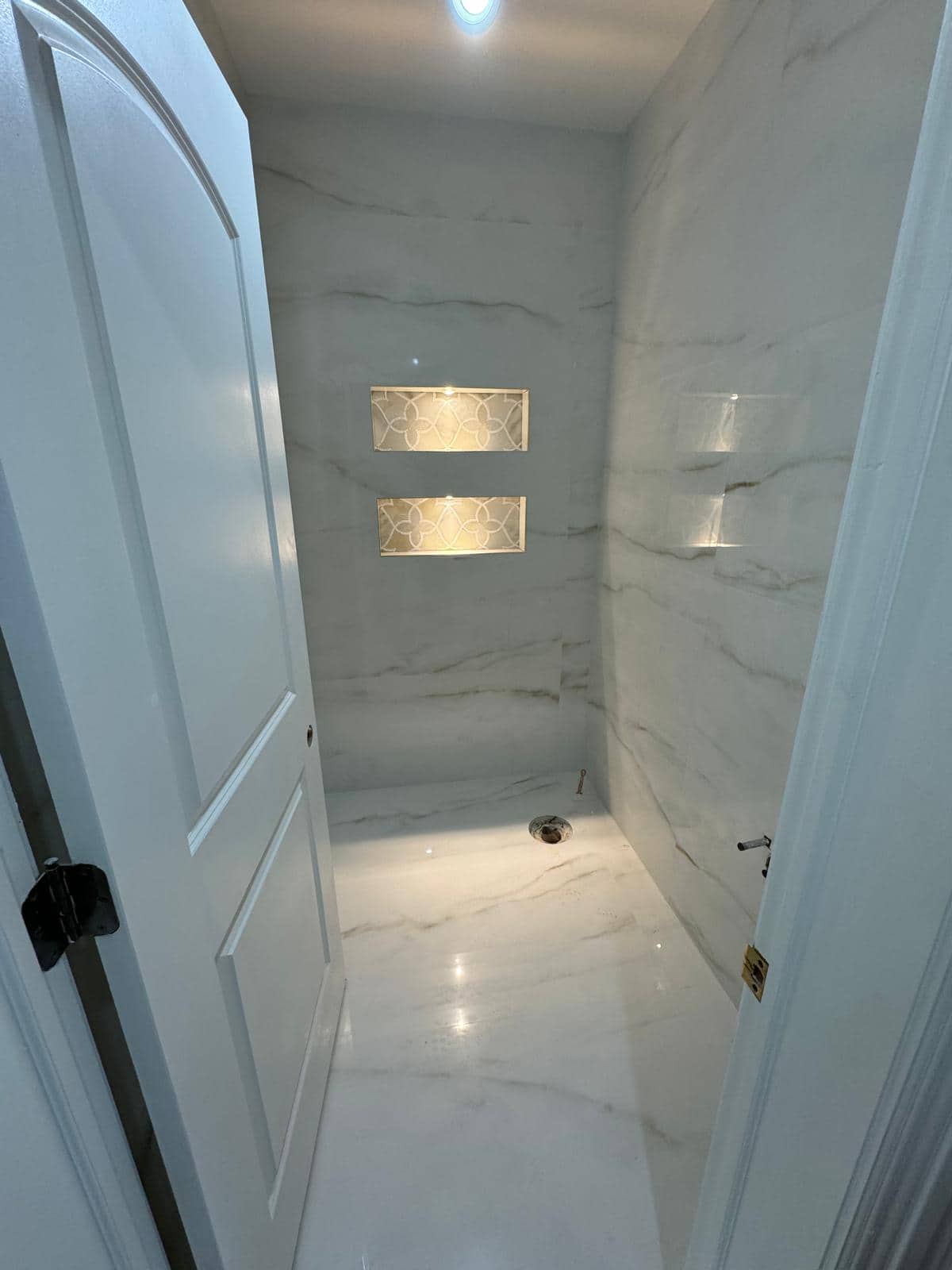 Marble-look shower stall and bathroom tile detail for a Woodside bathroom remodeling planning guide.