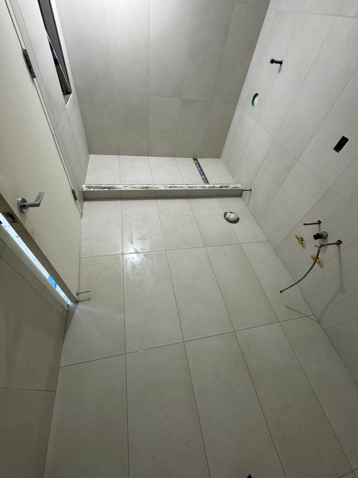 White tile shower remodel detail for an Astoria, Queens bathroom planning guide.